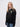 Newnham student wearing a black 1/4 zip sweatshirt
