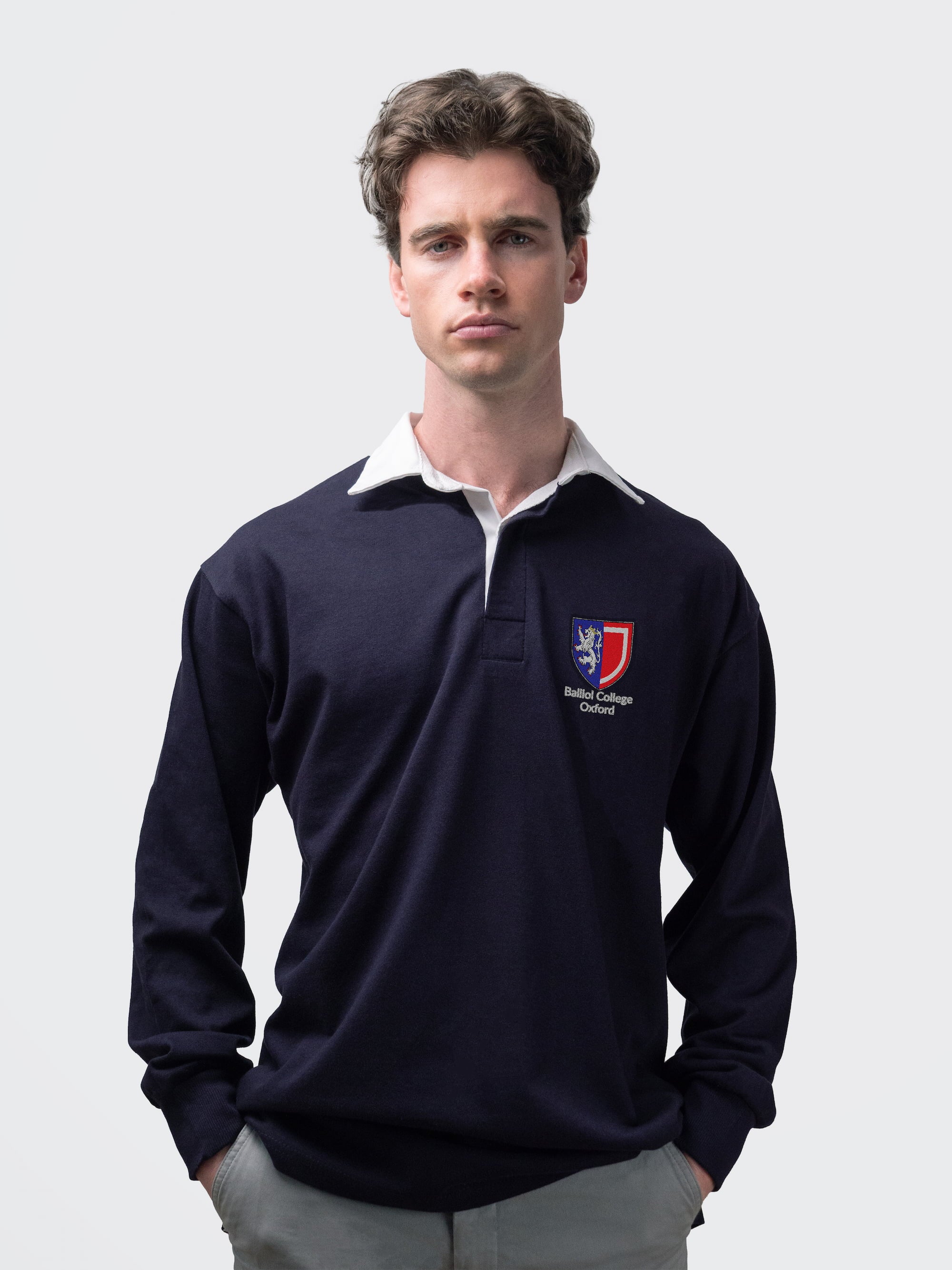 Balliol student wearing an embroidered mens rugby shirt in navy