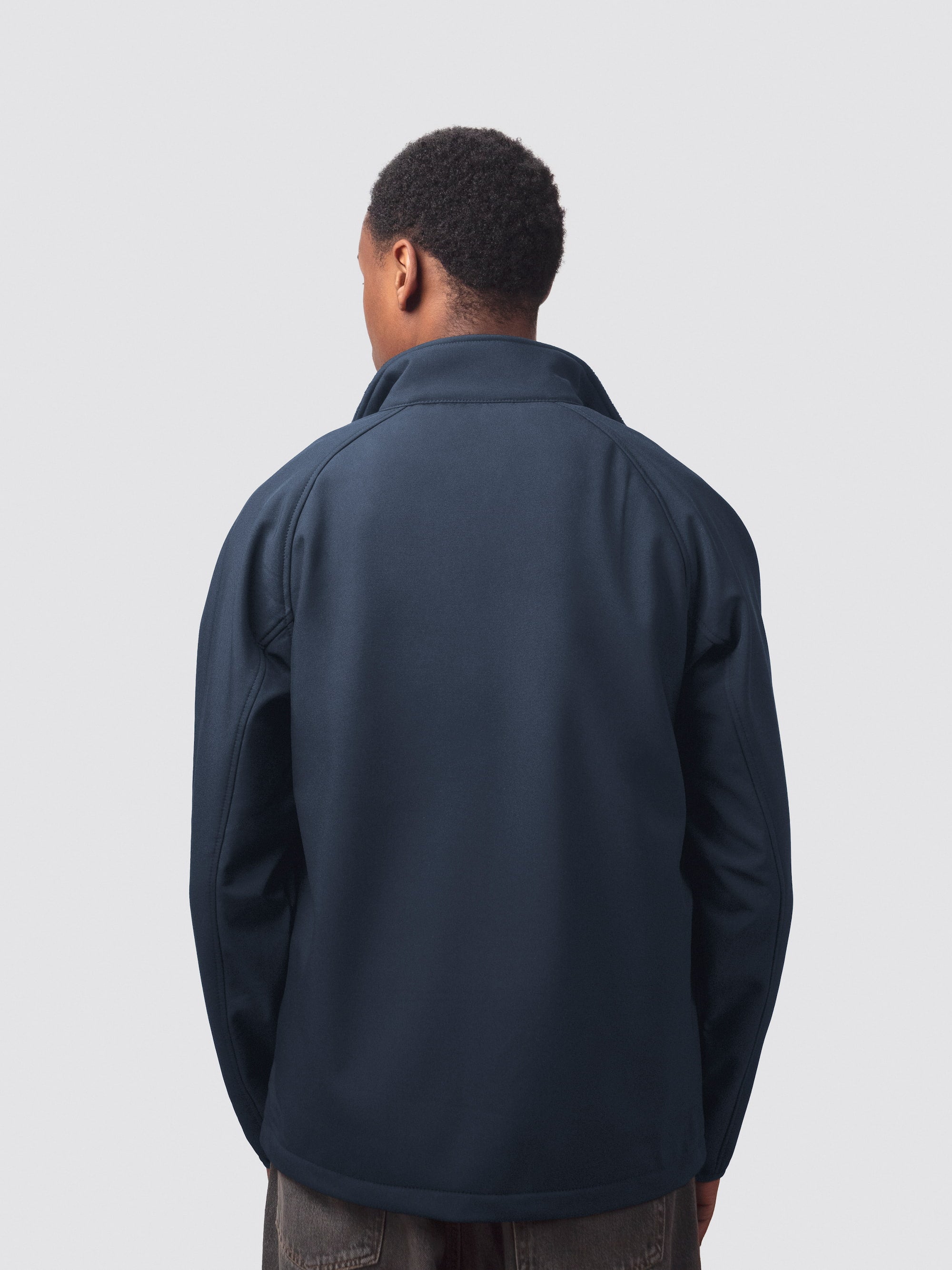 The back of a soft shell jacket, worn by a university student