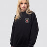 Collingwood crest on the front of a black, crew-neck sweatshirt