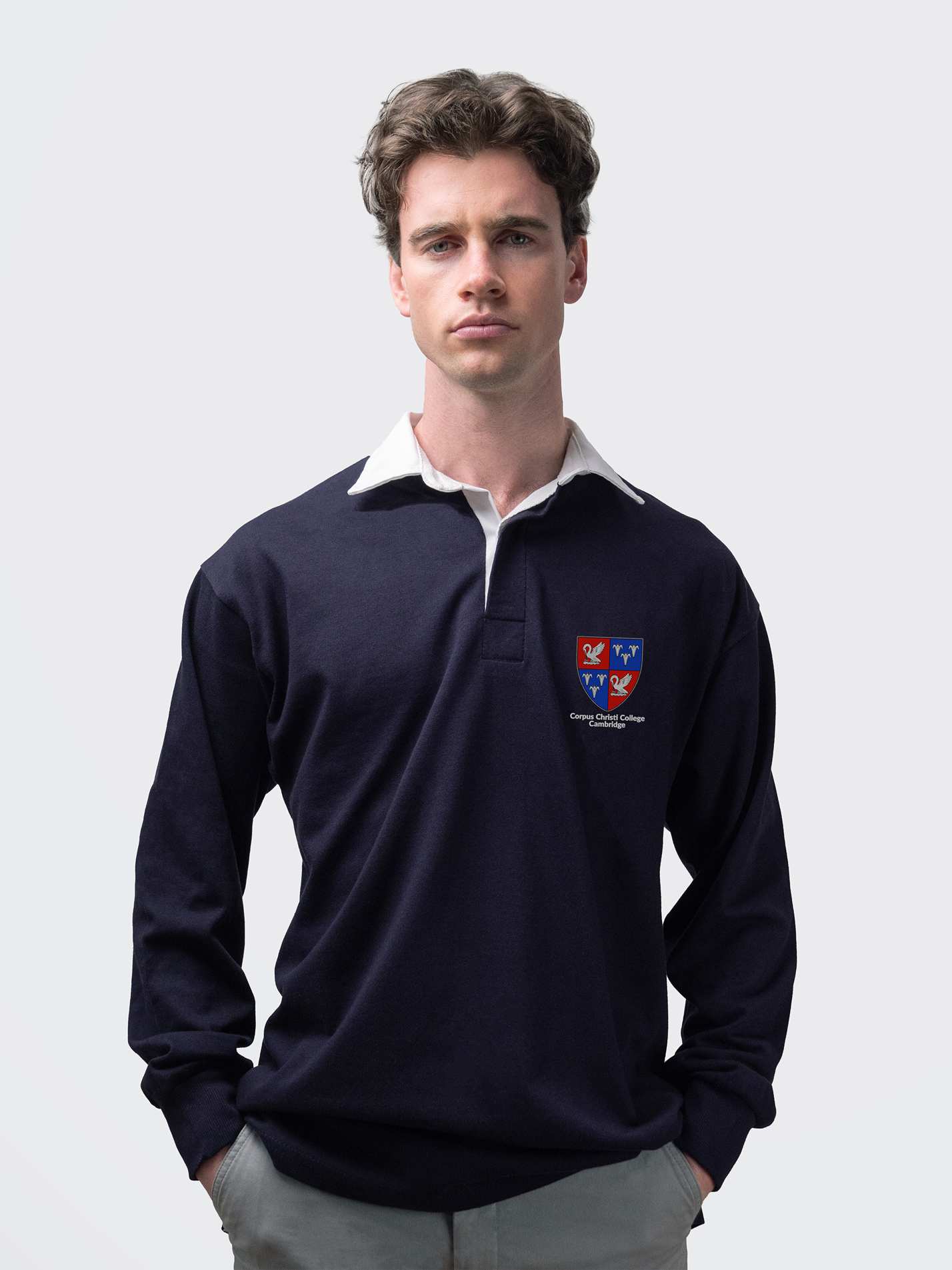 Corpus Christi student wearing an embroidered mens rugby shirt in navy