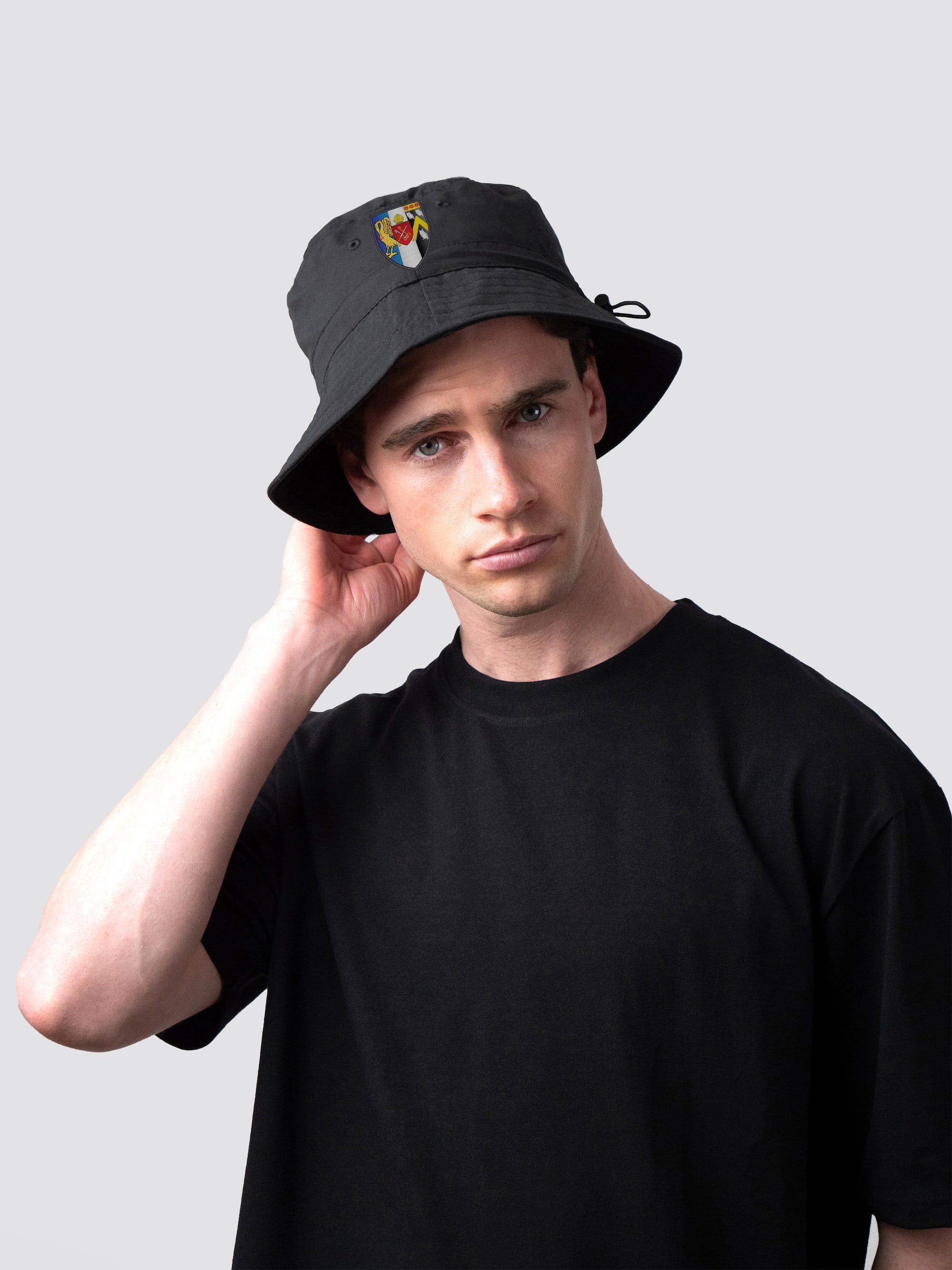 Black bucket hat, with embroidered Corpus Christi College crest