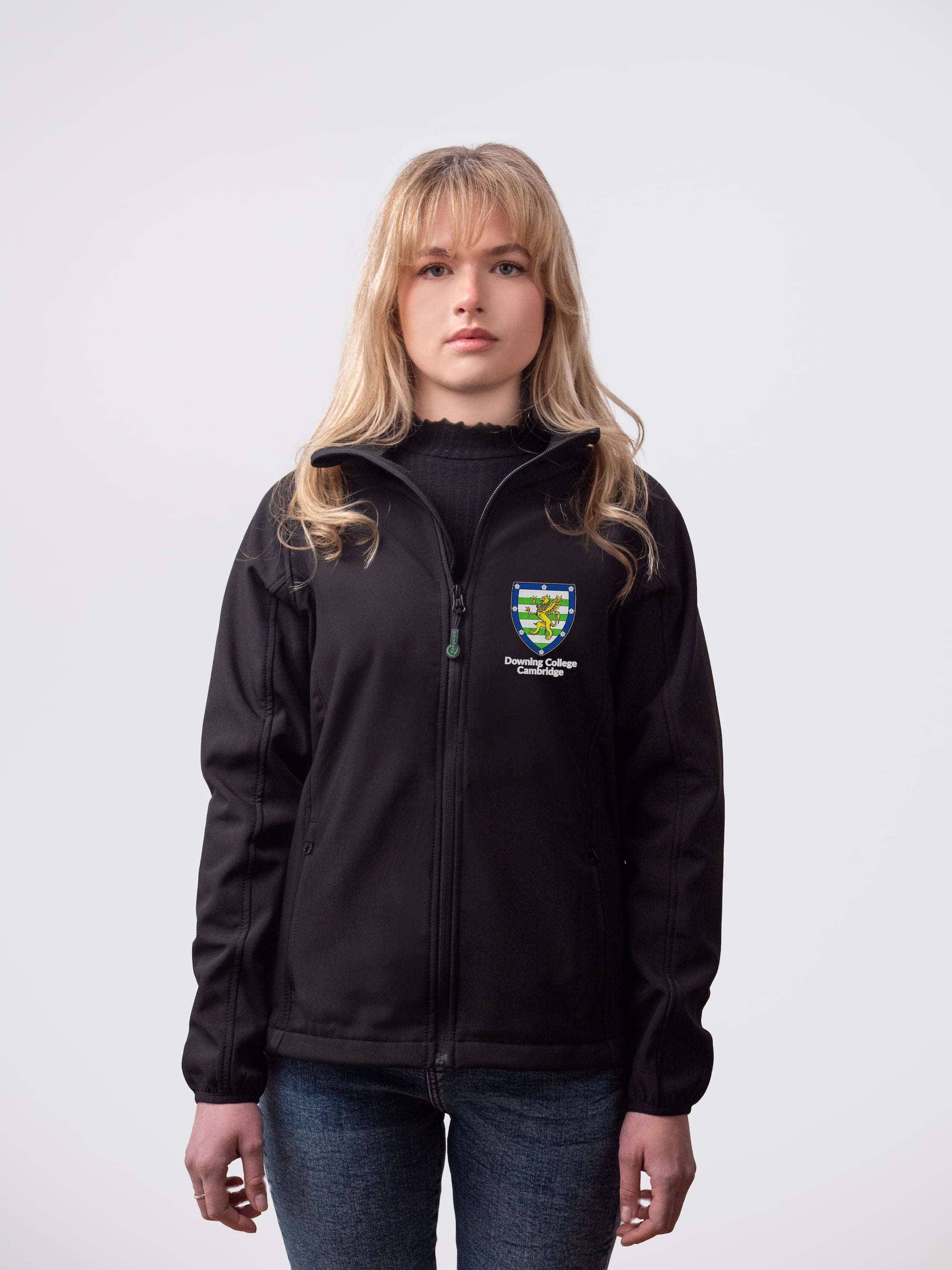 A student wearing a sustainable, Downing College embroidered jacket