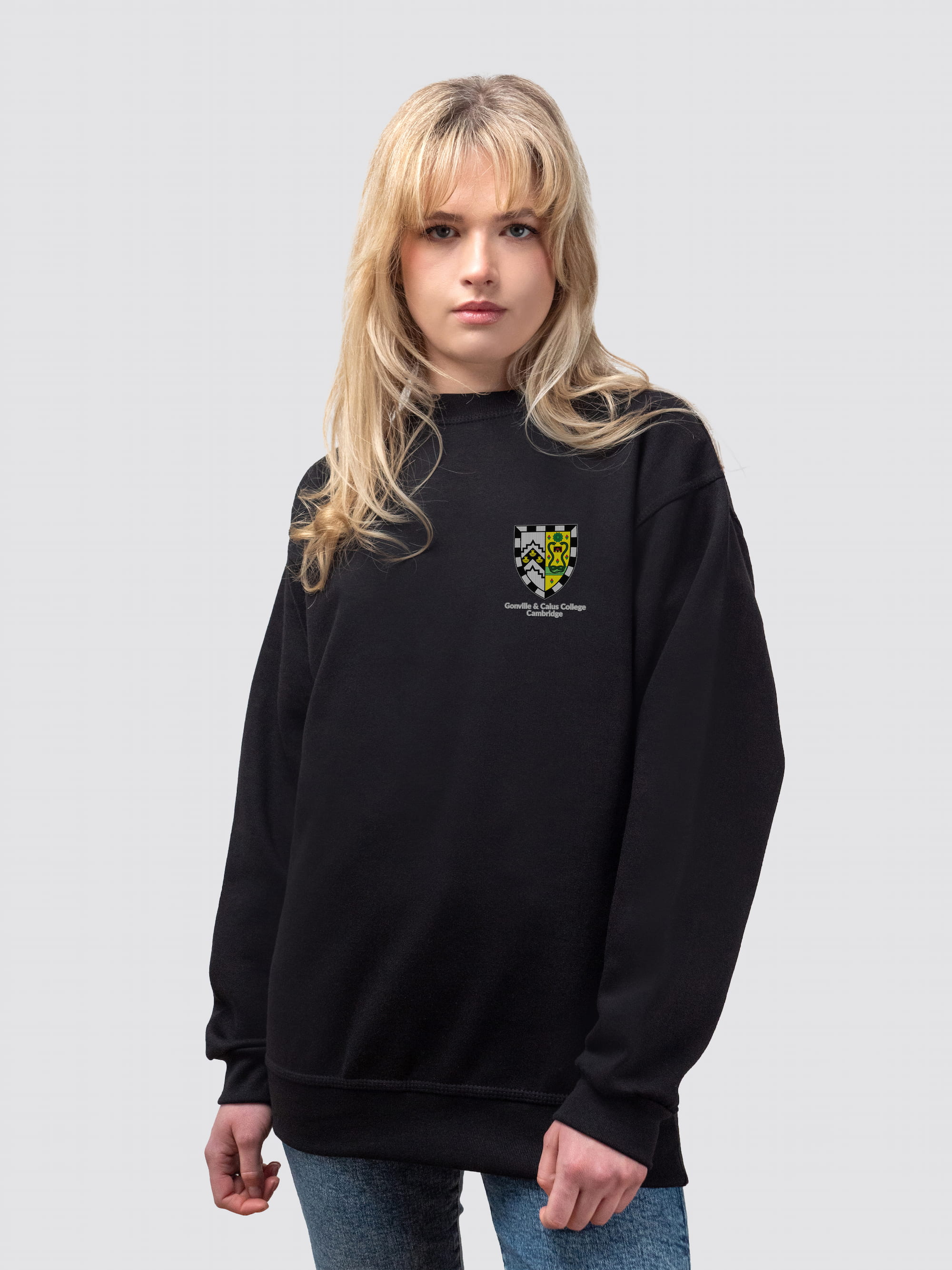 Gonville & Caius crest on the front of a black, crew-neck sweatshirt