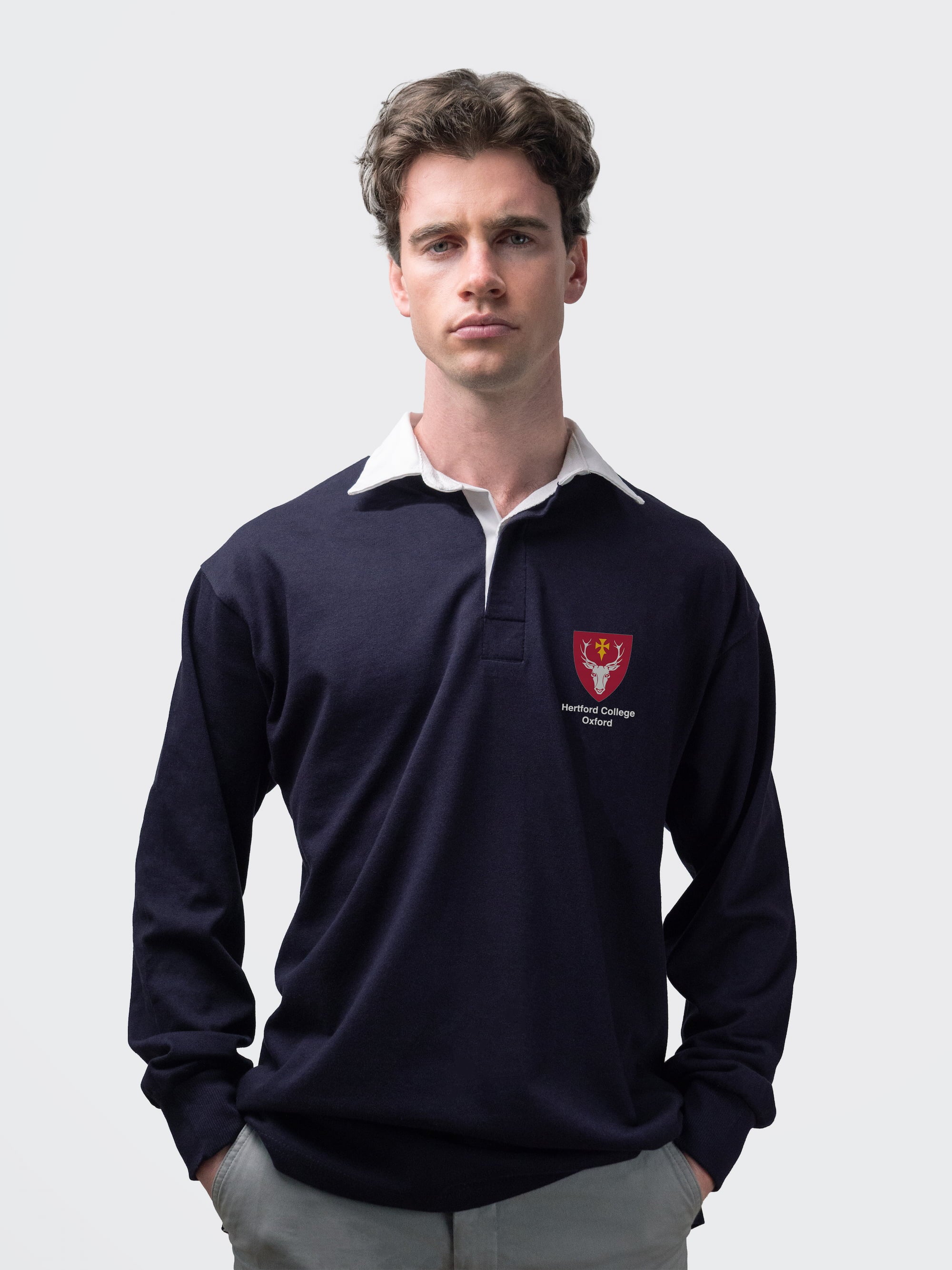 Hertford student wearing an embroidered mens rugby shirt in navy