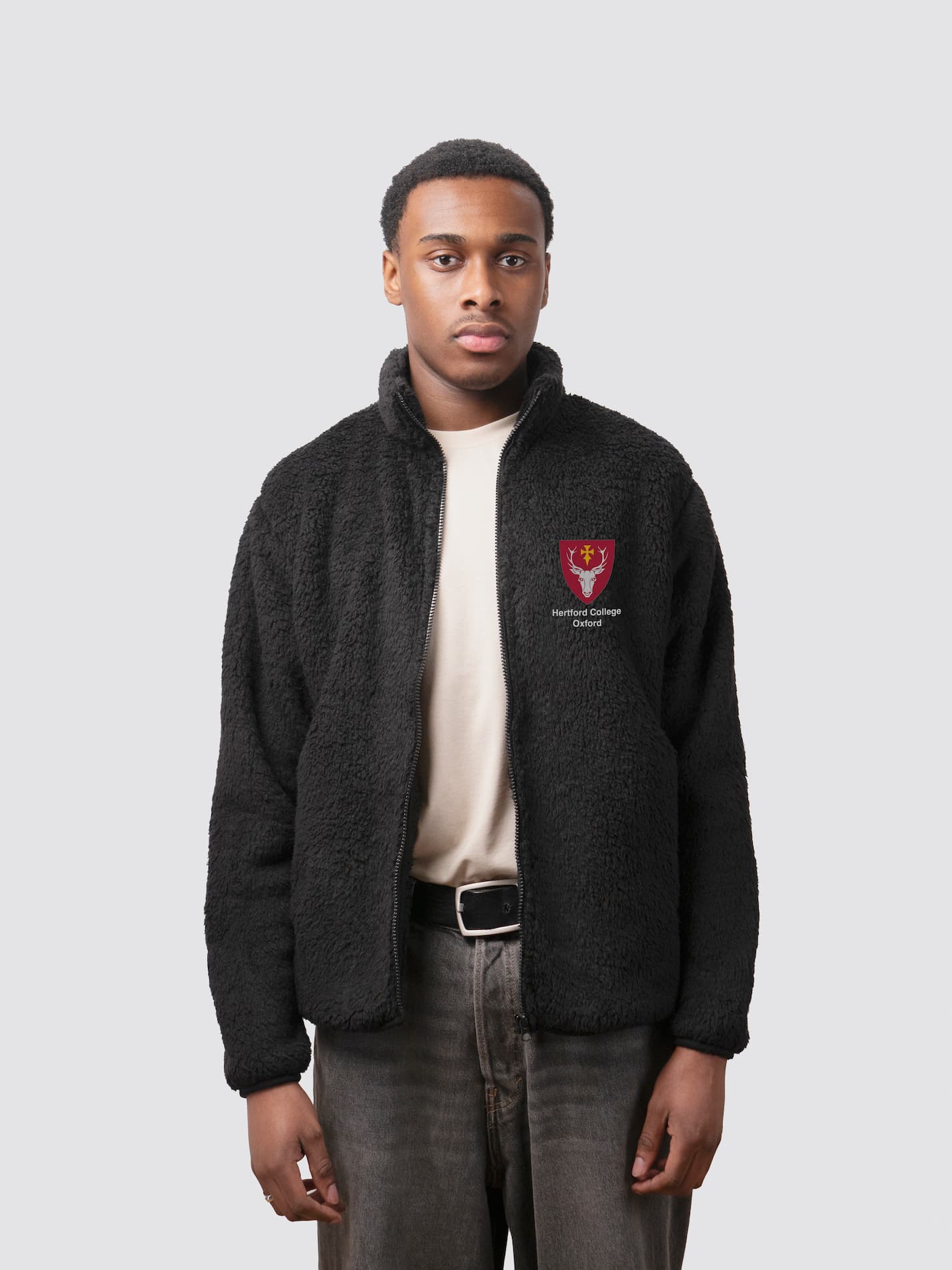 Fluffy black full zip sherpa fleece, with embroidered college crest on the left chest