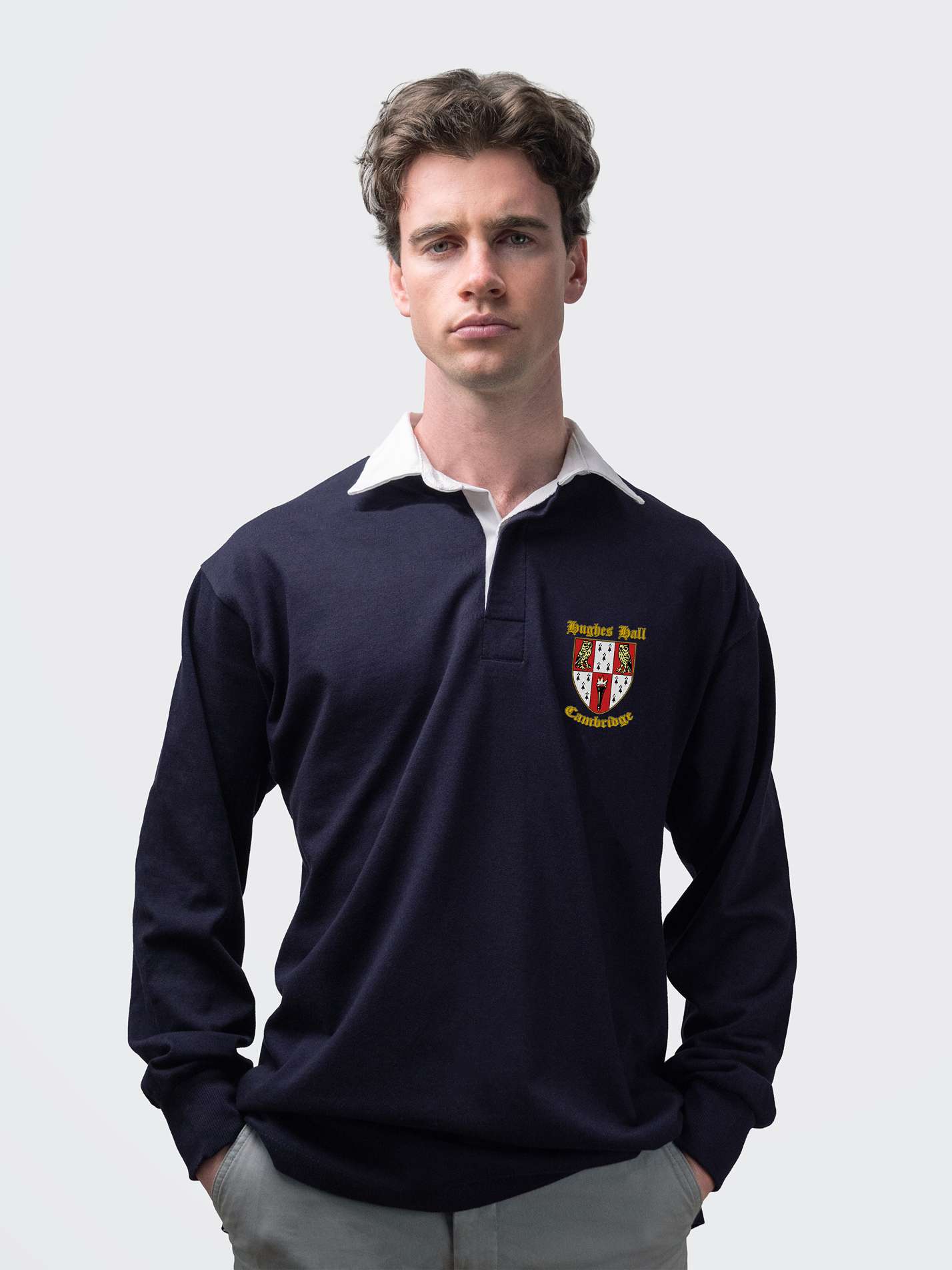Hughes Hall student wearing an embroidered mens rugby shirt in navy