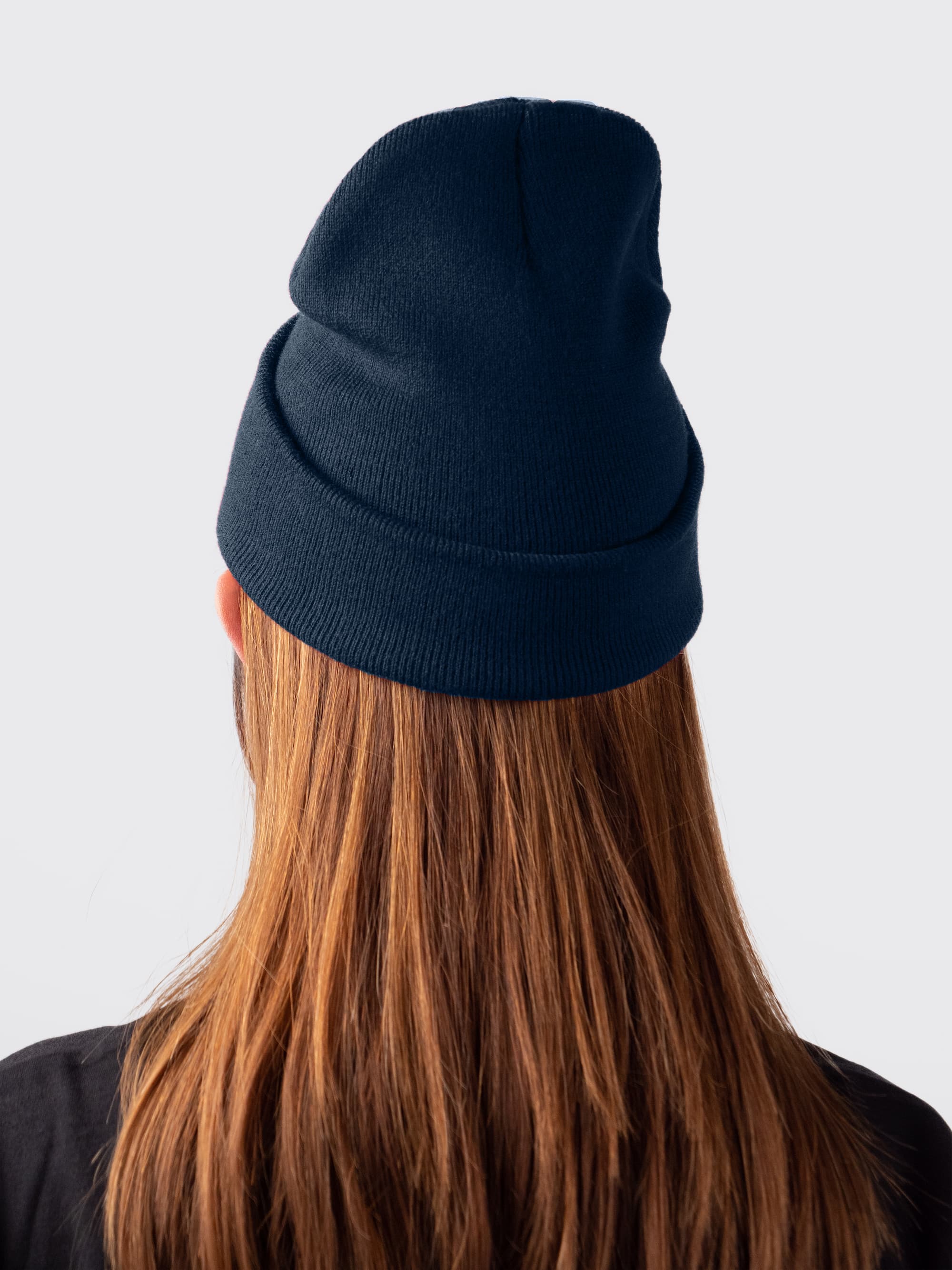 A female student wearing a navy beanie for the winter weather 