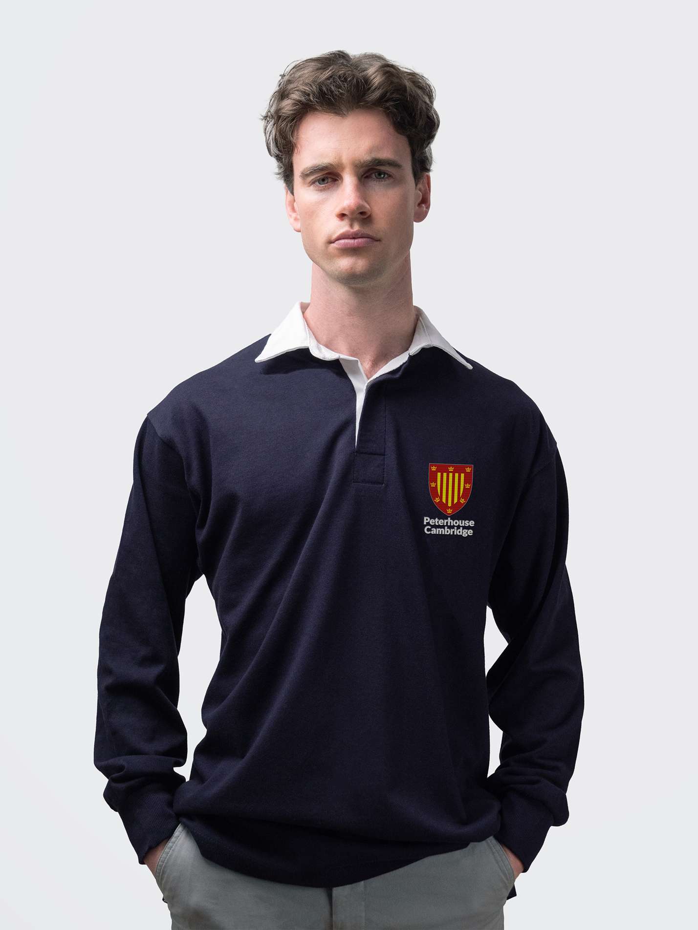 Peterhouse student wearing an embroidered mens rugby shirt in navy