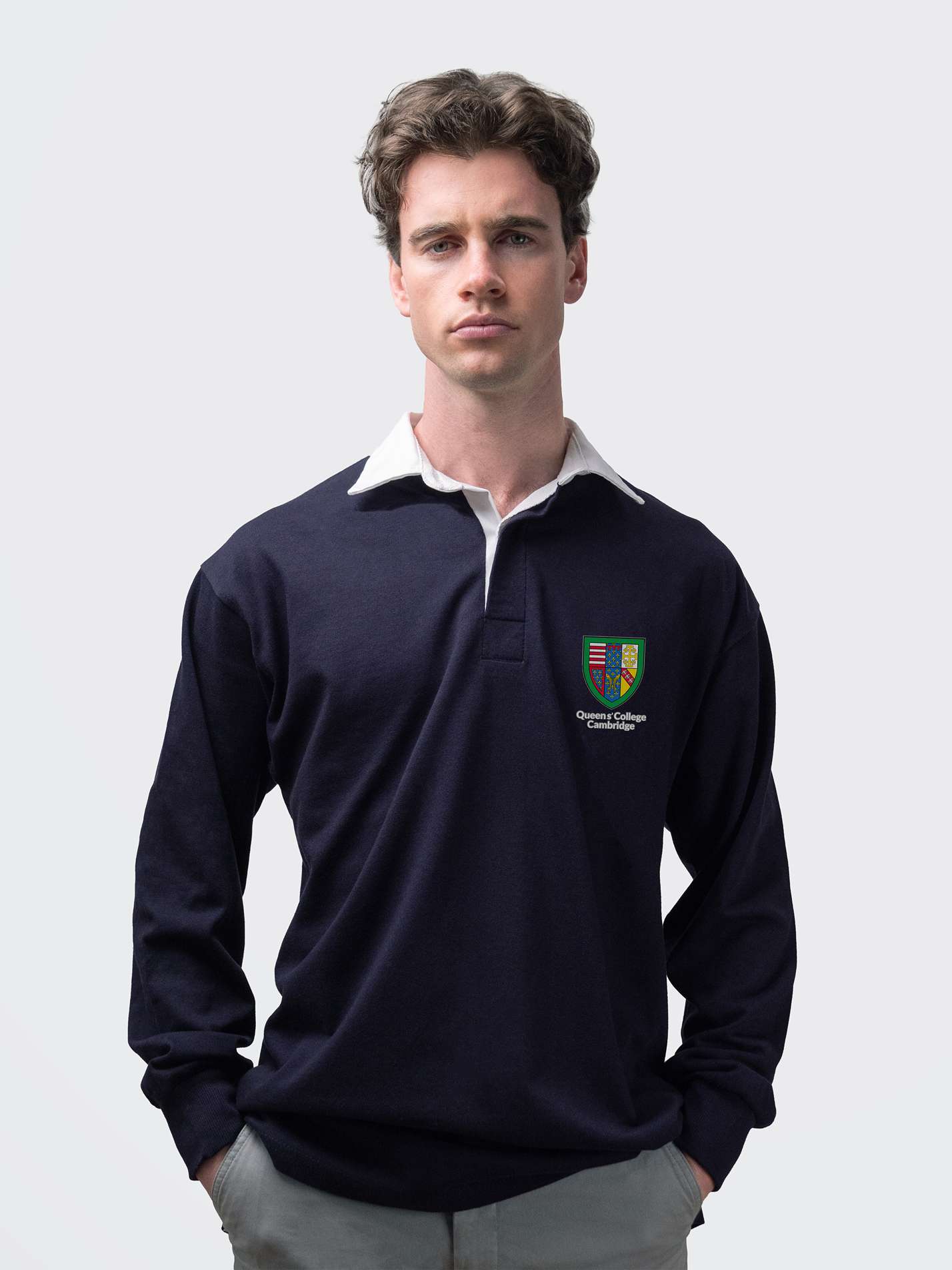 Queens' student wearing an embroidered mens rugby shirt in navy