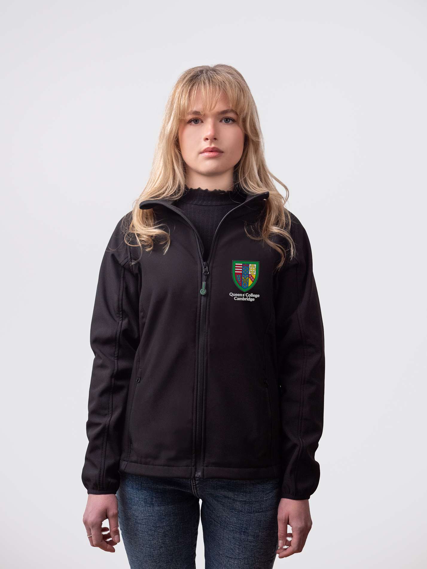 A student wearing a sustainable, Queens' College embroidered jacket