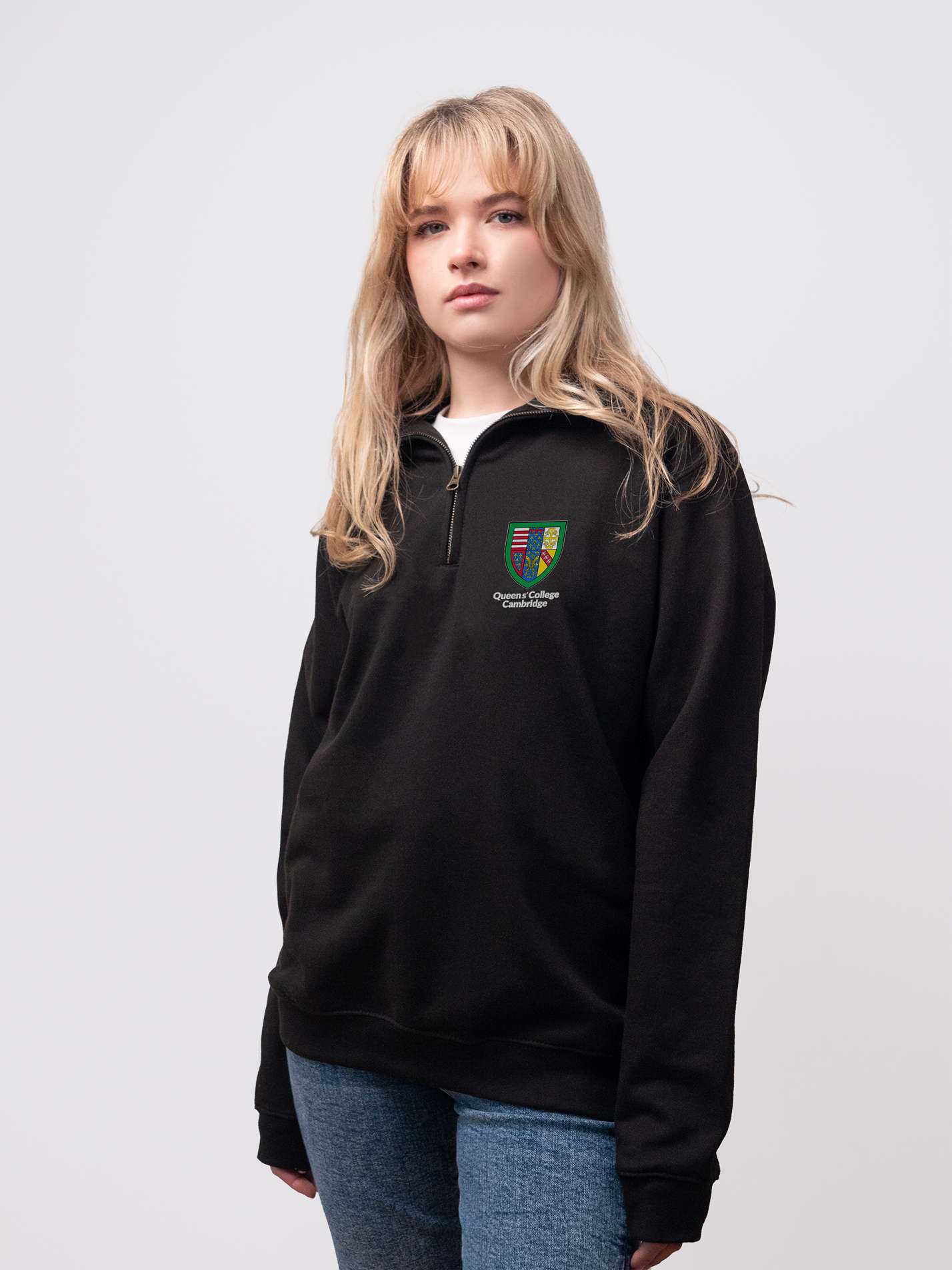 Queens' student wearing a black 1/4 zip sweatshirt 