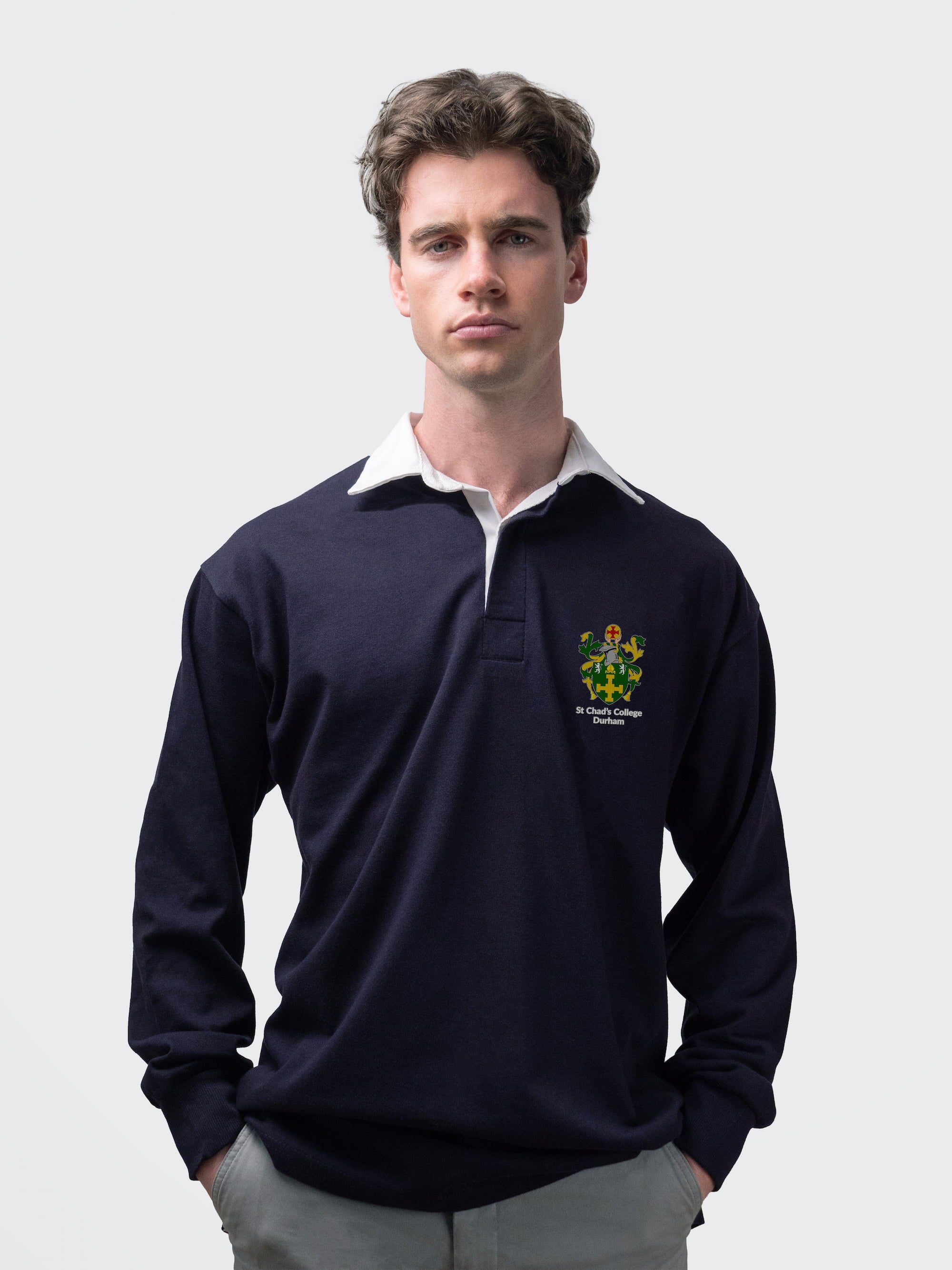 St Chad's student wearing an embroidered mens rugby shirt in navy