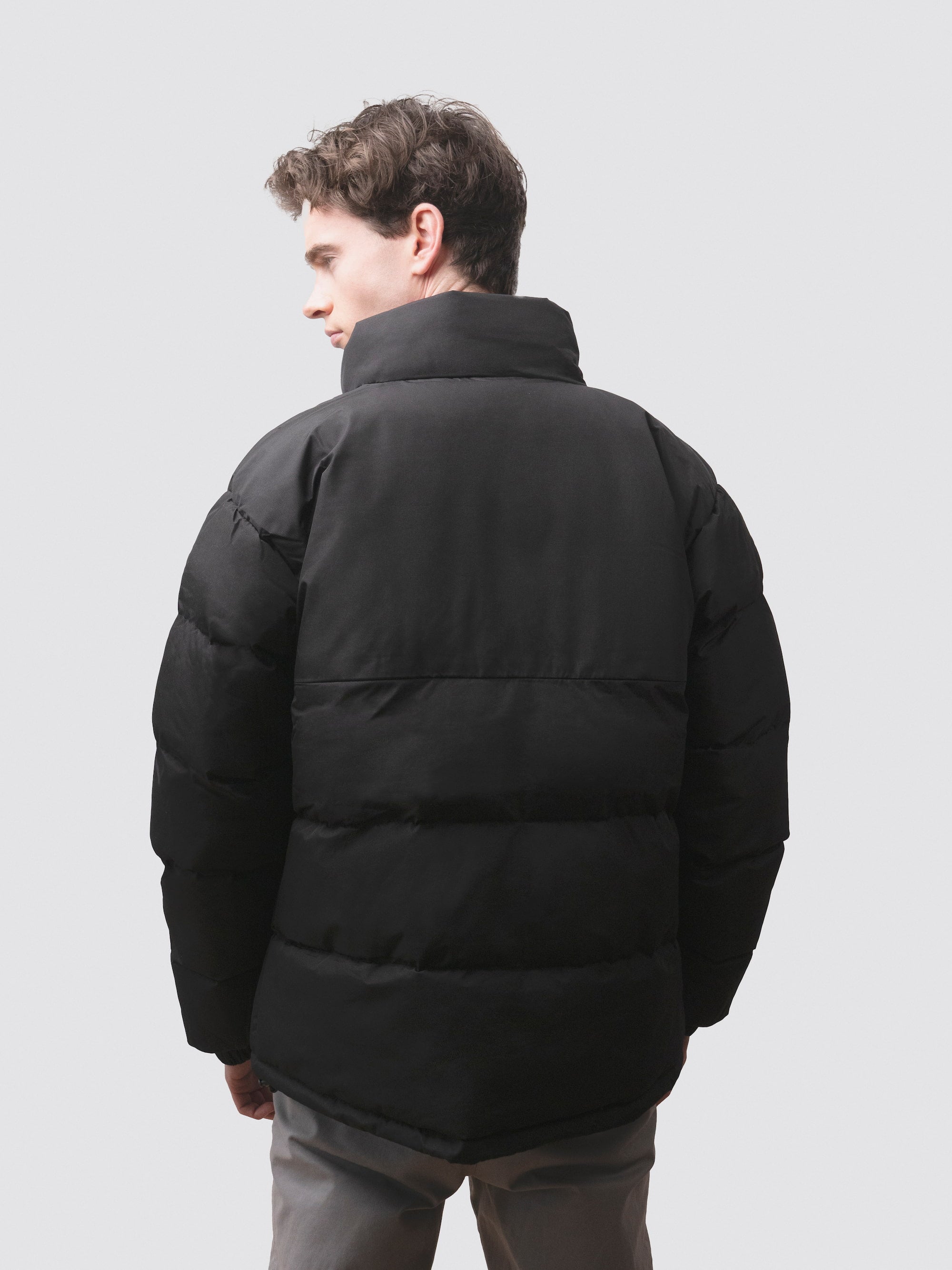 The back of a black, men’s puffer jacket from redbird