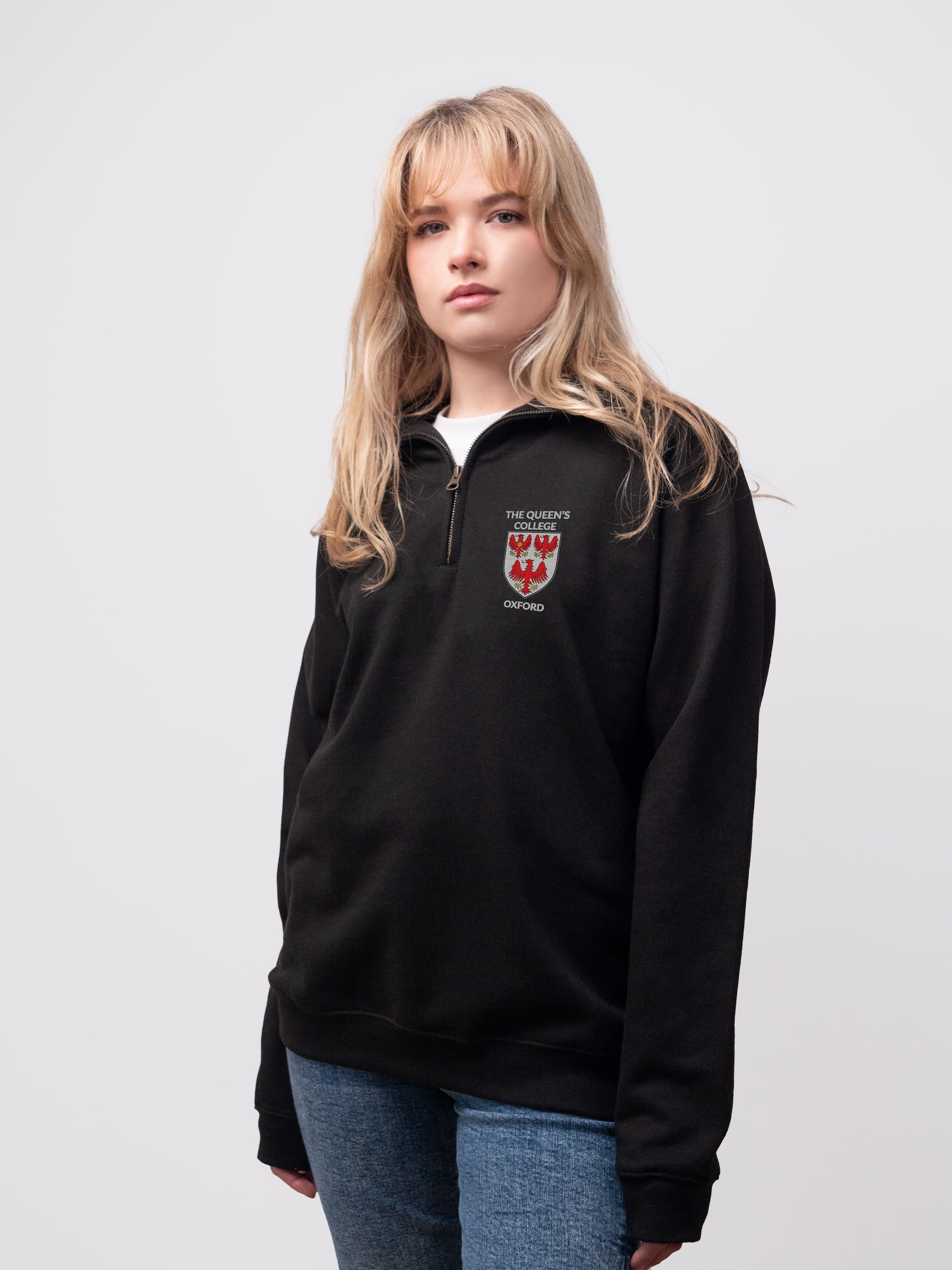 The Queen's student wearing a black 1/4 zip sweatshirt 