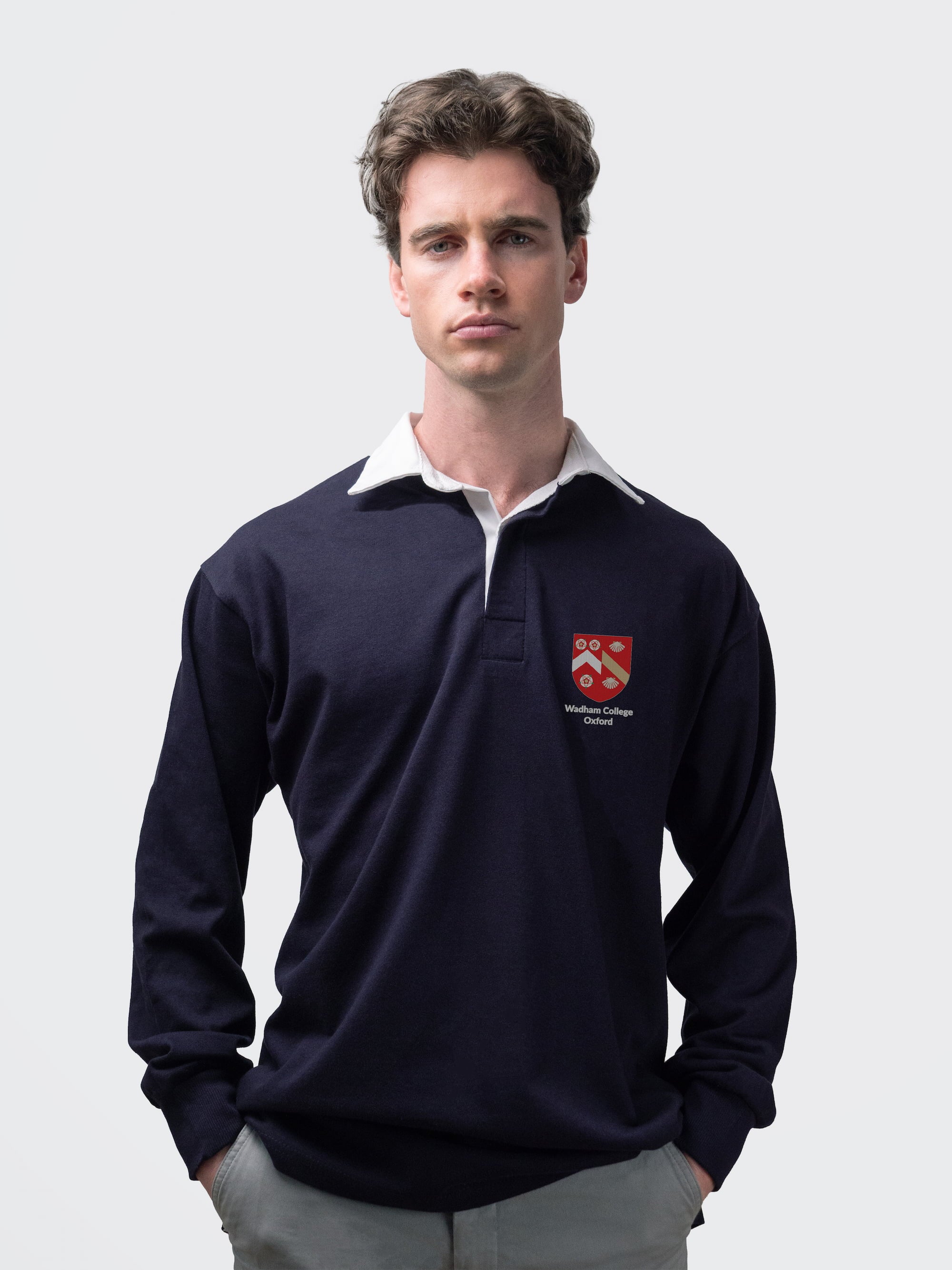 Wadham student wearing an embroidered mens rugby shirt in navy
